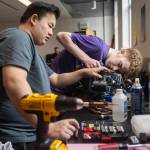 Ty Gross and Apollo Graves check wiring on the Edmonds College Marine ROV teams equipment on Wednesday, June 3, 2026 in Edmonds, Washington. (Olivia Vanni / The Herald)