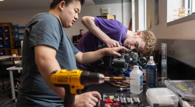 Ty Gross and Apollo Graves check wiring on the Edmonds College Marine ROV teams equipment on Wednesday, June 3, 2026 in Edmonds, Washington. (Olivia Vanni / The Herald)