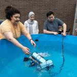 Shere Beshay places the teams ROV, named Razorbill, into a small pool for testing on Wednesday, June 3, 2026 in Edmonds, Washington. (Olivia Vanni / The Herald)