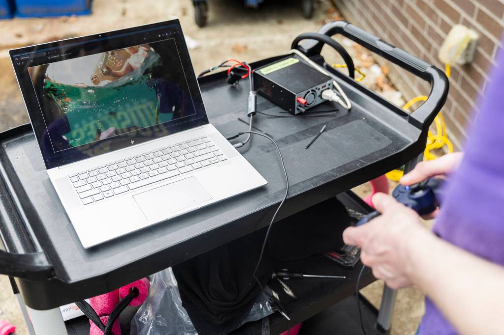 Apollo Graves uses a camera on the ROV to find items in the pool during testing on Wednesday, June 3, 2026 in Edmonds, Washington. (Olivia Vanni / The Herald)