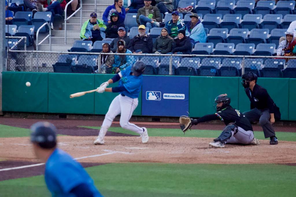 AquaSox catcher Luke Stevenson drives in a run during Everetts 12-2 win against the Eugene Emeralds at Everett Memorial Stadium on June 4, 2026. (Joe Pohoryles / The Herald)