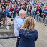 Former U.S. Rep. Brian Baird, left, speaks to a crowd next to Natasha Ryan, spokesperson for the city of Edmonds, during a launch for Edmonds Serves on Saturday in Edmonds. Edmonds is officially the nations first Community of Service under an initiative led by Baird. (Michael Henneke / The Herald)