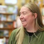 Melissa Foozer, an employee at Edmonds Bookshop, speaks during a launch for Edmonds Serves on Saturday in Edmonds. Edmonds Bookshop is one of multiple businesses that displays Edmonds Serves posters. (Michael Henneke / The Herald)