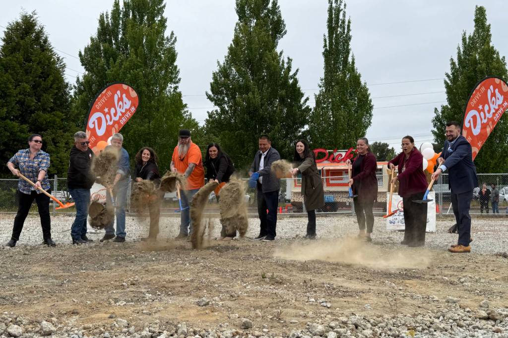 Members of the Tulalip Tribes board of directors and representatives from Dicks Drive-In break ground on the new restaurant location Monday in Tulalip. (Jenna Millikan / The Herald)