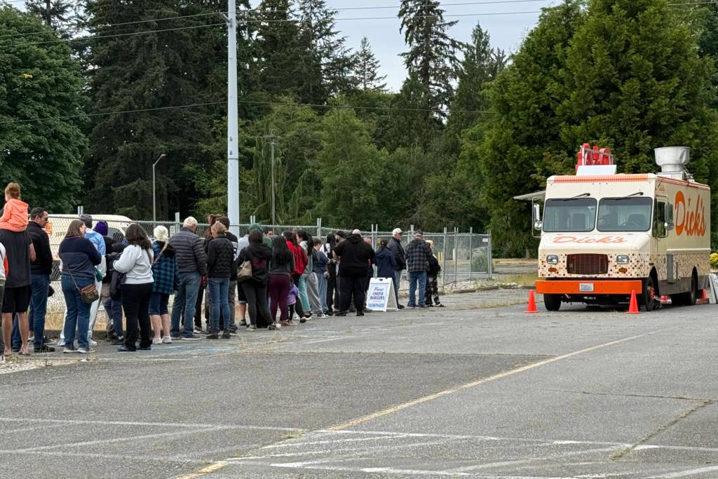 A line forms at a Dicks Drive-In food truck giving away free cheeseburgers during the groundbreaking of the new location Monday in Tulalip. (Jenna Millikan / The Herald)