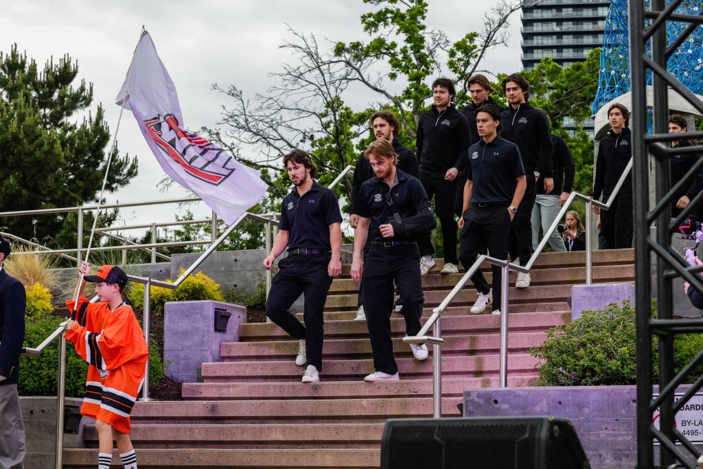 Silvertips captain Tarin Smith (right, in sling) leads the team out during the Memorial Cup arrival ceremony outside Prospera Place on May 21, 2026. (Photo courtesy Steve Dunsmoor / CHL)