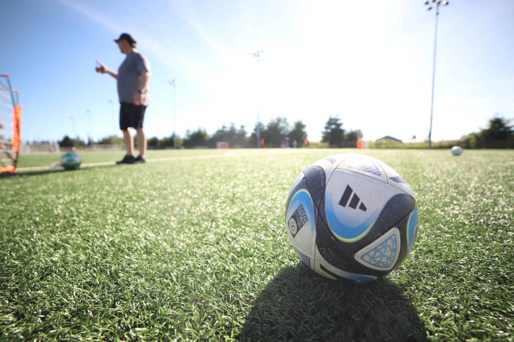 Matt Tilton, left, head coach of Pilchuck Force, pauses at the start of practice at at the Strawberry Fields Athletic Complex on Thursday in Marysville. (Michael Henneke / The Herald)