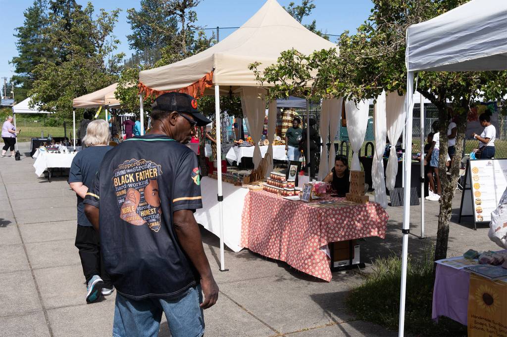 Attendees browse vendor booths during a Juneteenth celebration on Friday, June 19, 2026, in Lynnwood, Washington. (Will Geschke / The Herald)