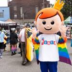 A Funko mascot stands with a Pride flag during the Everett Pride block party on Saturday, June 20, 2026, in Everett, Washington. (Will Geschke / The Herald)