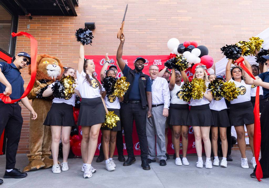 Raising Canes Restaurant Leader Tay Hicks and Lynwood Mayor George Hurst cut the ribbon for the grand opening of the Raising Canes Lynnwood location on Tuesday, June 23, 2026 in Lynnwood, Washington. (Olivia Vanni / The Herald)