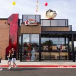 People walk through the parking lot of the new Raising Canes on Tuesday, June 23, 2026 in Lynnwood, Washington. (Olivia Vanni / The Herald)