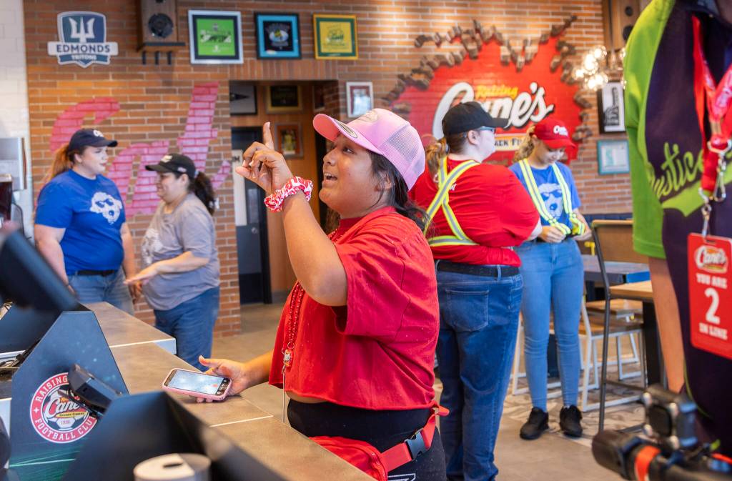 Rosa Murillo, the first person in line for the Raising Canes grand opening who has been camped out since yesterday at noon, places her order on Tuesday, June 23, 2026 in Lynnwood, Washington. (Olivia Vanni / The Herald)