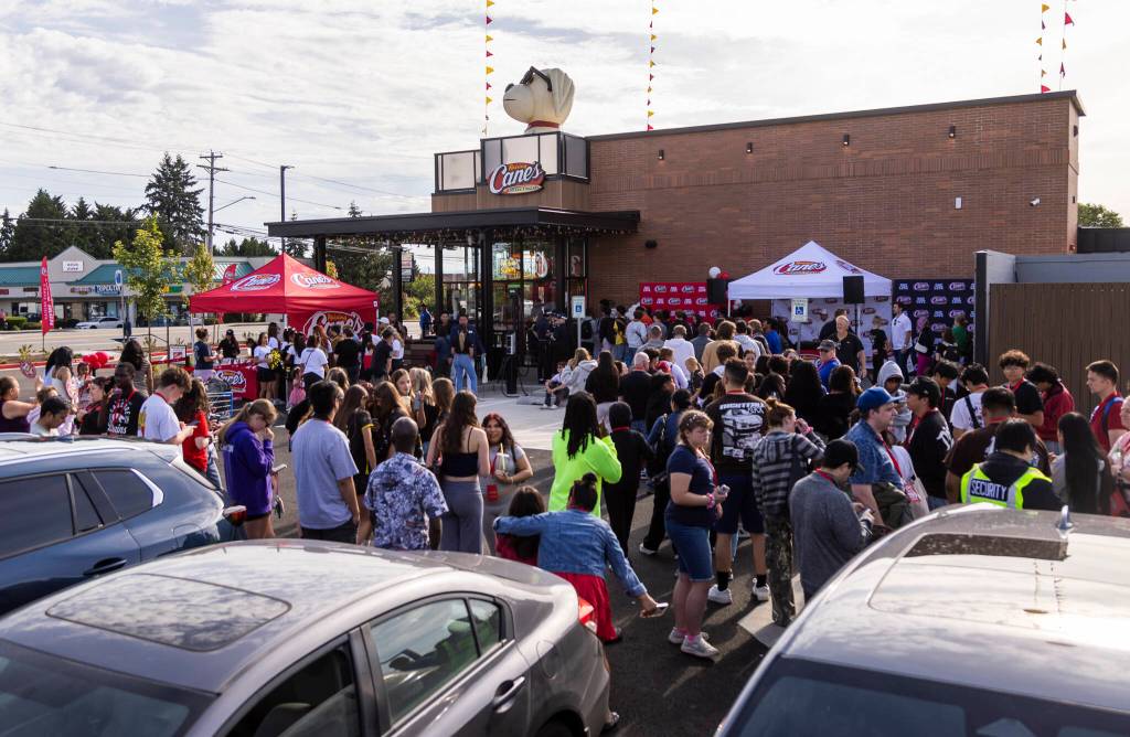 People wait in line to place their orders during the Raising Canes grand opening on Tuesday, June 23, 2026 in Lynnwood, Washington. (Olivia Vanni / The Herald)