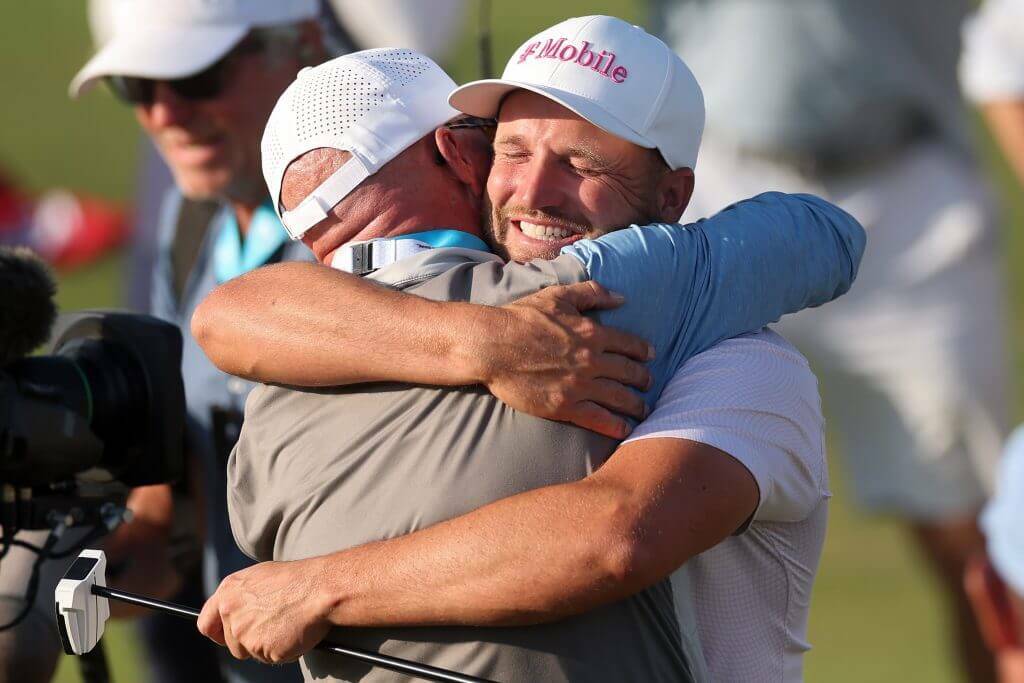 Wyndham Clark of the United States celebrates with father Randall Clark after winning the 126th U.S. OPEN at Shinnecock Hills Golf Club on Sunday in Southampton, New York. (Christian Petersen / Getty Images / The Athletic)