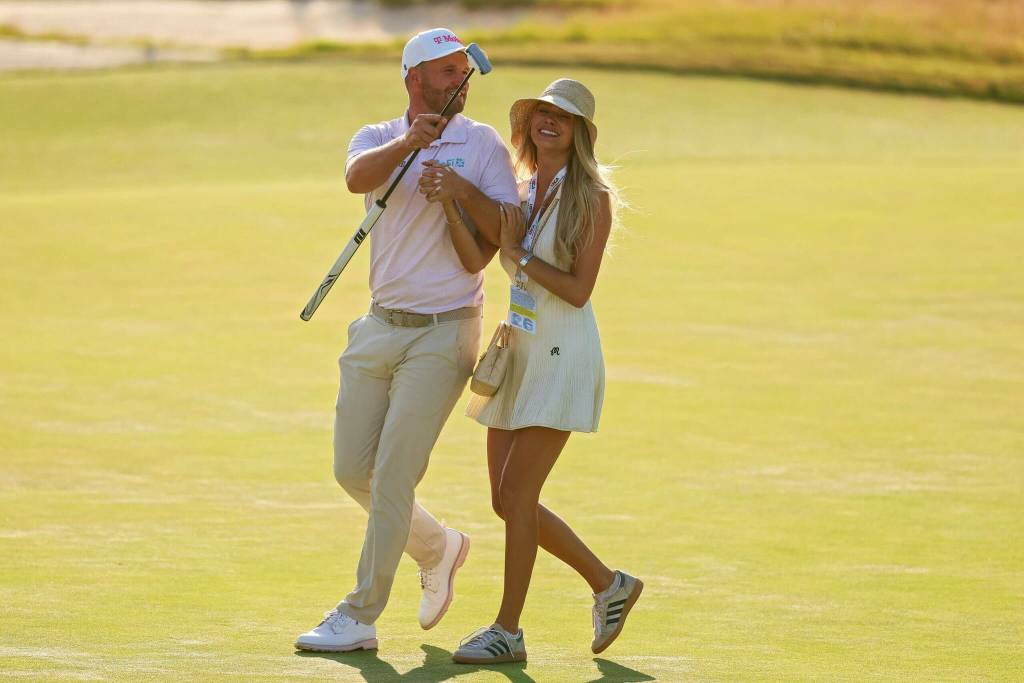 Wyndham Clark of the United States celebrates with girlfriend Emily Tanner after winning the 126th U.S. OPEN at Shinnecock Hills Golf Club on Sunday in Southampton, New York. (Getty Images / The Athletic)