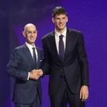 NBA commissioner Adam Silver, left, shakes hands with former Washington Huskies star Hannes Steinbach after he is drafted 14th overall by the Charlotte Hornets during the first round of the NBA Draft at Barclays Center on Tuesday, June 23, 2026, in New York. (Arturo Holmes / Getty Images / Tribune News Services)