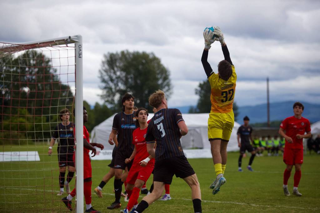 Bigfoot FC goalkeeper Landon Gordon leaps to secure a cross during Snohomish Uniteds 3-0 win at Stocker Fields on June 26, 2026. (Joe Pohoryles / The Herald)