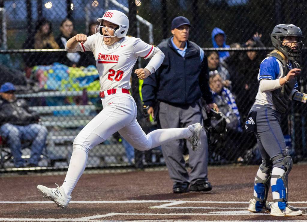 Stanwoods Addi Anderson yells as she crosses home plate to score the go-ahead run during the 3A District 1 championship game against Sedro-Woolley on Thursday, May 15, 2025 in Everett, Washington. (Olivia Vanni / The Herald)