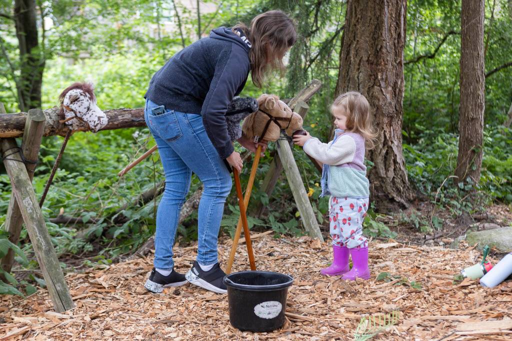 Mae Silva, 2, plays with the horse toys with her nanny, Shelby Husby, at Vaughns Teaching Farm and Kitchen on Thursday, June 25, 2026 in Lynnwood, Washington. (Olivia Vanni / The Herald)