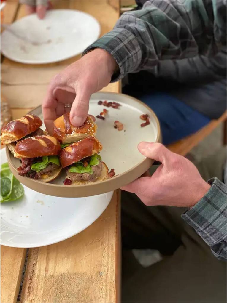 Sliders being served at a Farm to Table Dinner. (Goat & Seed)