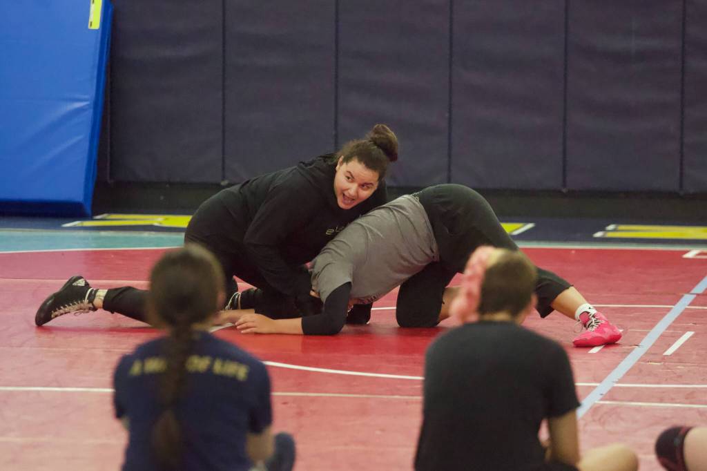 Former Kamiak state champion Ally de la Cruz teaches a move during the Kamiak girls wrestling camp at Mariner High School on June 30, 2026. (Joe Pohoryles / The Herald)