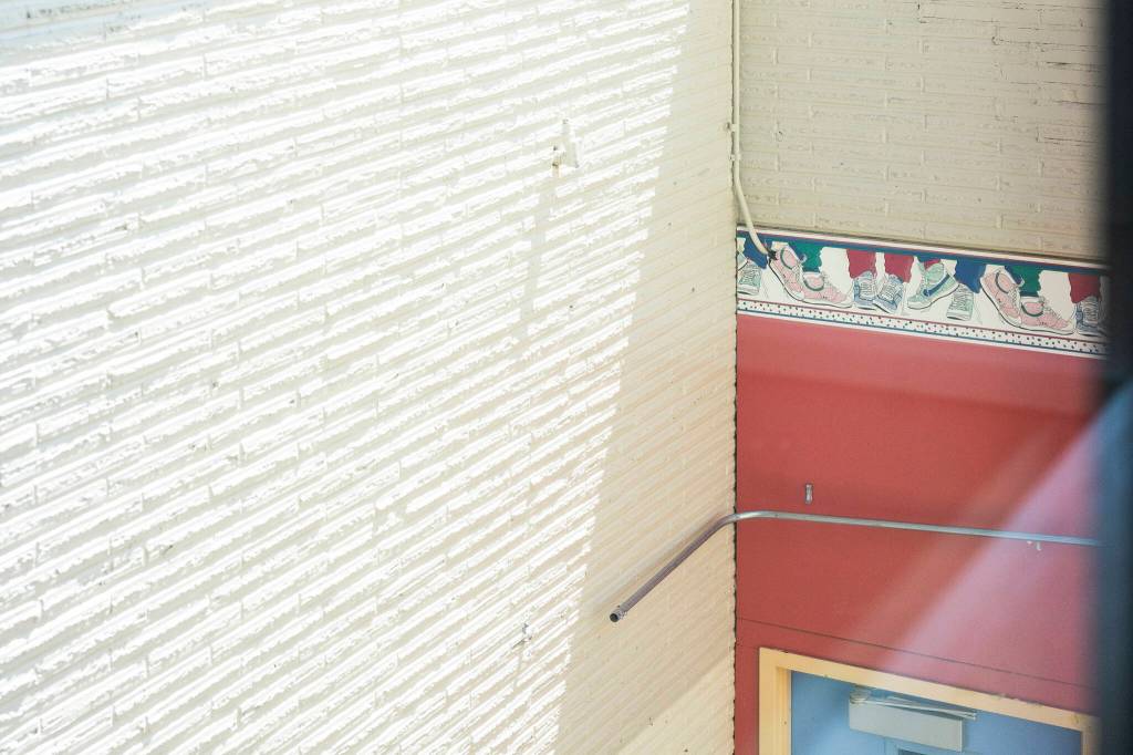 Wallpaper from the previous gym at Jackson Elementary School is visible on the exterior of the old school on Tuesday, July 7, 2026 in Everett, Washington. (Olivia Vanni / The Herald)