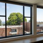 A view of the old Jackson Elementary School from the second floor of the new Jackson Elementary School building on Tuesday, July 7, 2026, in Everett, Washington. (Olivia Vanni / The Herald)