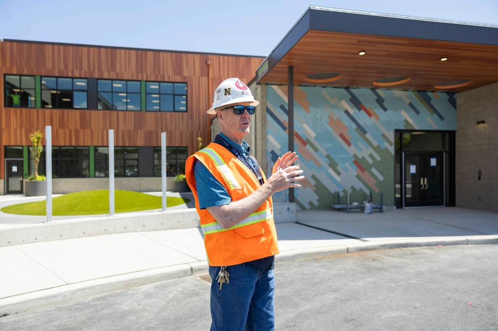 Everett Public Schools Director of Capitol Projects Darcy Walker walks about the new bus drop off and pick up entry at the new Jackson Elementary School on Tuesday, July 7, 2026, in Everett, Washington. (Olivia Vanni / The Herald)