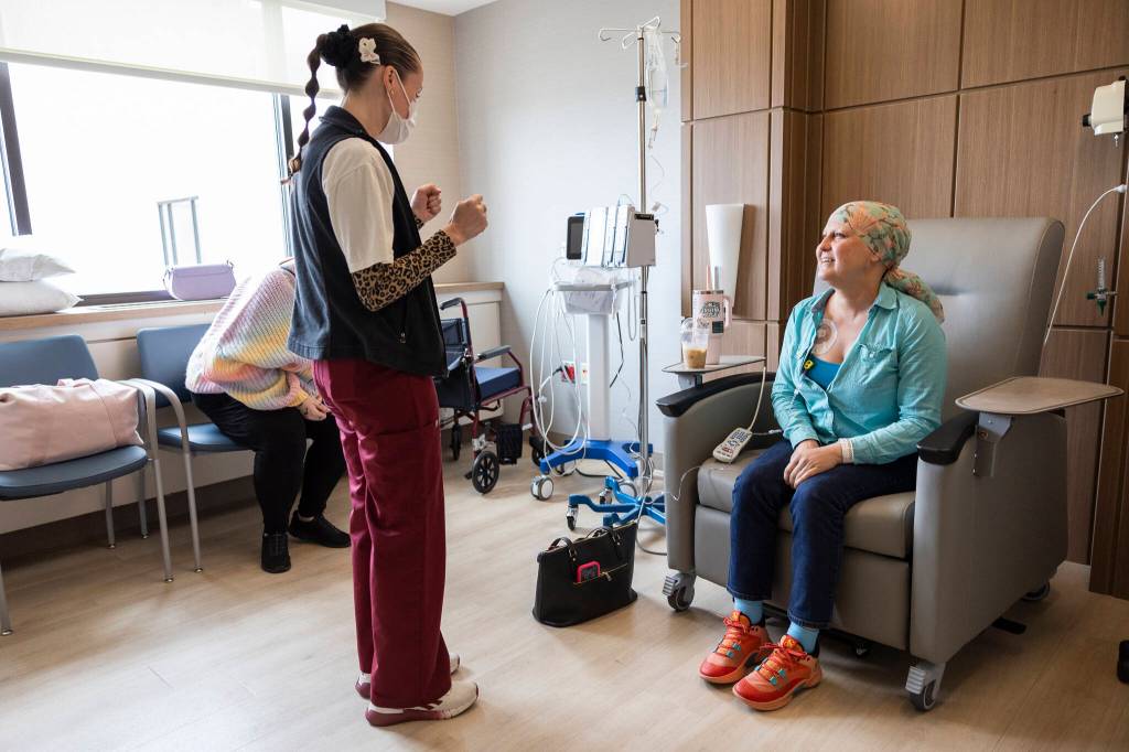 Infusion nurse Leinani Medellin talks with patient Chelsea Doser during her treatment at the infusion center at Providence Regional Medical Center Everett on Thursday, July 2, 2026, in Everett, Washington. (Olivia Vanni / The Herald)