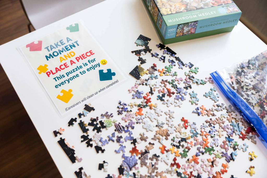 A puzzle covers a table in a waiting area for family, friends and patients at the infusion center at Providence Regional Medical Center Everett on Thursday, July 2, 2026 in Everett, Washington. (Olivia Vanni / The Herald)