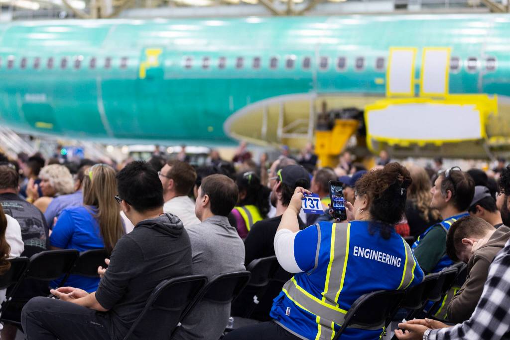 A Boeing engineer takes a photograph of a 737 memento at the ribbon-cutting for the North Line on Friday, July 10, 2026, in Everett, Washington. (Olivia Vanni / The Herald)