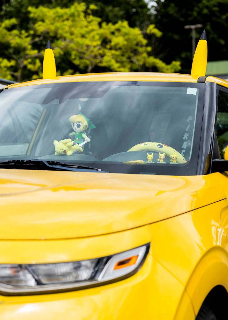 A yellow car with Pikachu ears and other Pikachu characters parked outside of GeekFest West on Friday, July 17, 2026, in Lynnwood, Washington. (Olivia Vanni / The Herald)