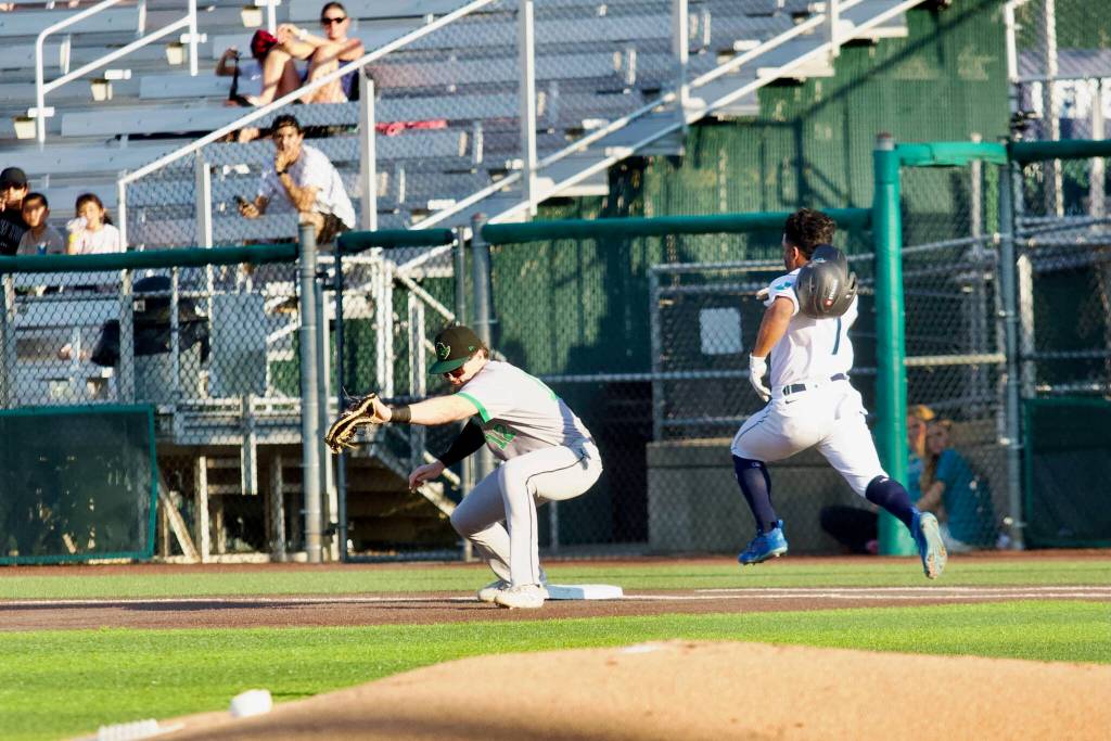 AquaSox infielder Ricardo Cova (right) tries to beat out a throw to first base during Everetts 13-8 loss to the Eugene Emeralds at Everett Memorial Stadium on July 21, 2026. (Joe Pohoryles / The Herald)