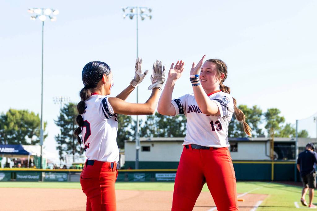 Snohomish Little League All Star softballs Jaliyah Wright (left) and Maddie Locke (right) high-five during a Little League Northwest Regional quarterfinal game against Oregon on Sunday, July 19, 2026 at Al Houghton Stadium in San Bernardino, Calif. (Photo Courtesy of Little League Baseball and Softball)