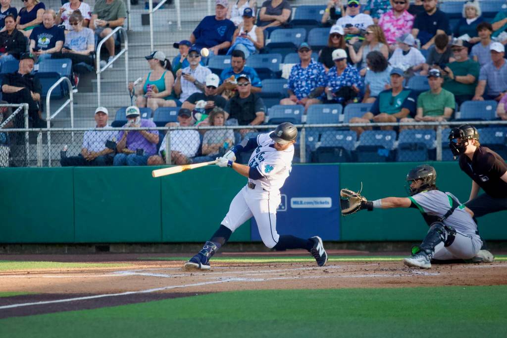 Mariners infielder Brendan Donovan makes contact during his rehab assignment with the Everett AquaSox at Everett Memorial Stadium on July 21, 2026. (Joe Pohoryles / The Herald)