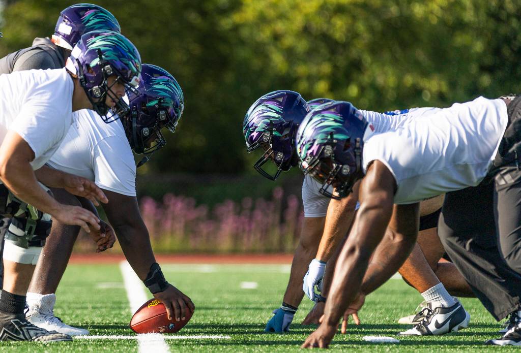 Washington Wolfpack players line up for a snap during practice on Friday, July 24, 2026 in Everett, Washington. (Olivia Vanni / The Herald)