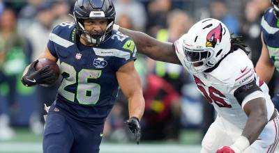 Zach Charbonnet (26) of the Seattle Seahawks runs against Darius Robinson (56) of the Arizona Cardinals in the fourth quarter of a game at Lumen Field on Sunday, Nov. 9, 2025, in Seattle. (Stephen Brashear / Getty Images / Tribune News Services)