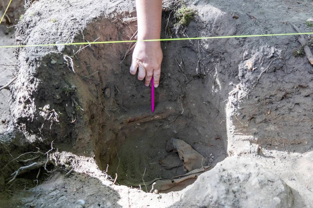 A leather jacket uncovered in one of the sites is pointed out on Tuesday, July 28, 2026 in Mukilteo, Washington. (Olivia Vanni / The Herald)