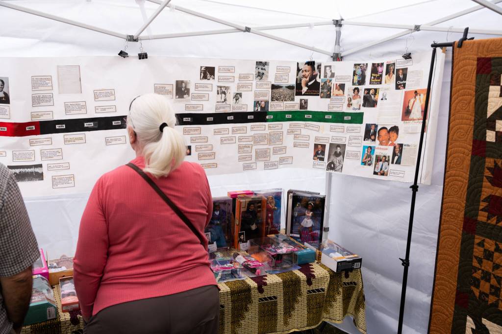 Attendees browse a history display during the 33rd annual Nubian Jam on Saturday, July 25, 2026, in Everett, Washington. (Will Geschke / The Herald)