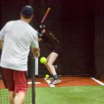 Snohomish All-Stars assistant coach Drew Locke (left) delivers a practice pitch to Layla Bailey at the Blast Barn in Snohomish on July 28, 2026. (Joe Pohoryles / The Herald)