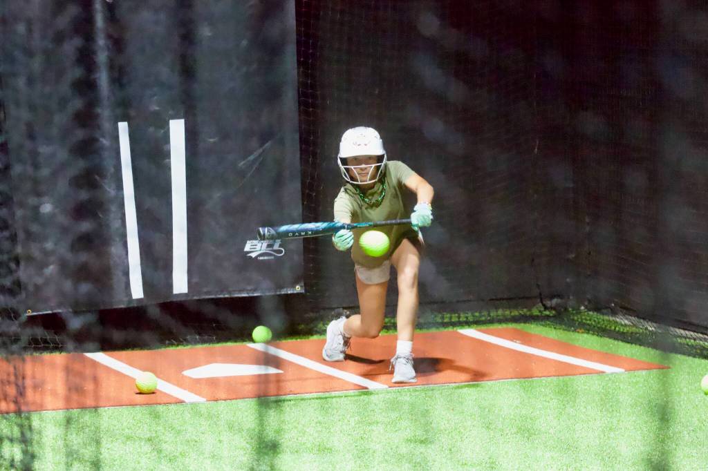 Kaia Hoolulu sets up for a bunt during the Snohomish All-Stars practice at the Blast Barn in Snohomish on July 28, 2026. (Joe Pohoryles / The Herald)