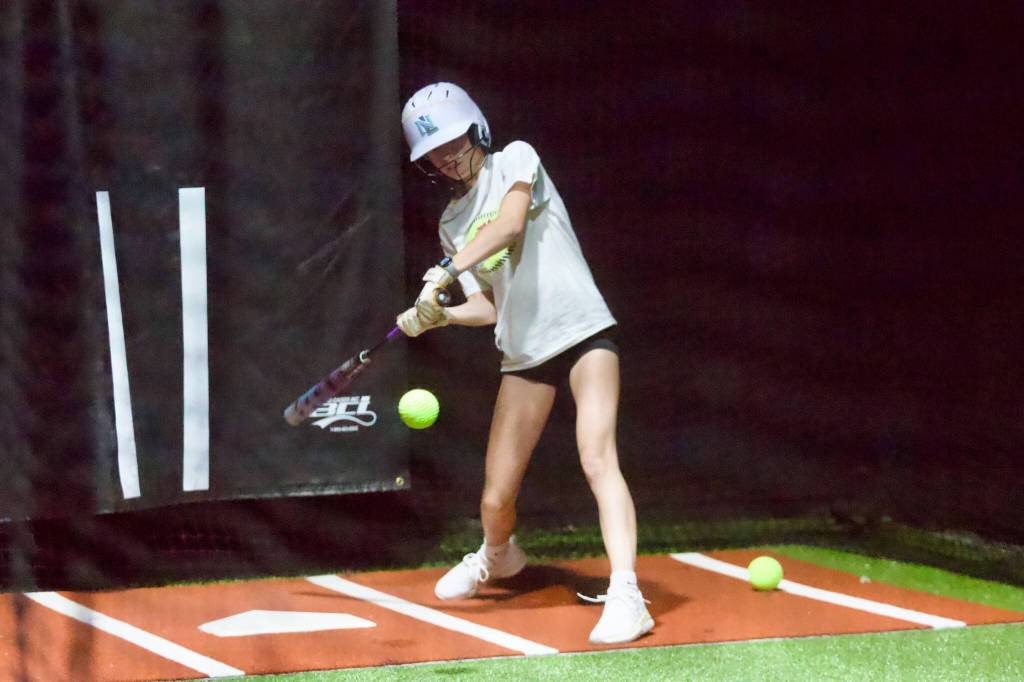 Hannah Choiniere swings at a pitch during the Snohomish All-Stars practice at the Blast Barn in Snohomish on July 28, 2026. (Joe Pohoryles / The Herald)