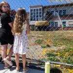 People gather to watch the start of demolition of Jackson Elementary School along Federal Avenue on Thursday, July 30, 2026 in Everett, Washington. (Olivia Vanni / The Herald)