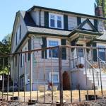 A 100-year-old home on Glenwood Avenue was damaged in a suspected arson after a hedge in the front yard caught fire on July 17, 2026, in Everett, Washington. (Ian Davis-Leonard/The Daily Herald)