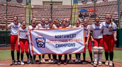 The Snohomish Little League All-Stars hold the Northwest Region championship banner on Thursday, July 23, 2026 at Al Houghton Stadium in San Bernardino, California. (Photo courtesy of Little League Baseball and Softball)