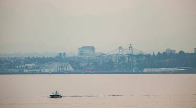 A boater cruises around Possession Sound as smoke blocks out the Cascades and shrouds downtown Everett in the distance on Friday, August 25, 2023, near Mukilteo, Washington. (Ryan Berry / The Herald)
A boater cruises around Possession Sound as smoke blocks out the Cascades and shrouds downtown Everett in the distance on Friday, August 25, 2023, near Mukilteo, Washington. (Ryan Berry / The Herald)