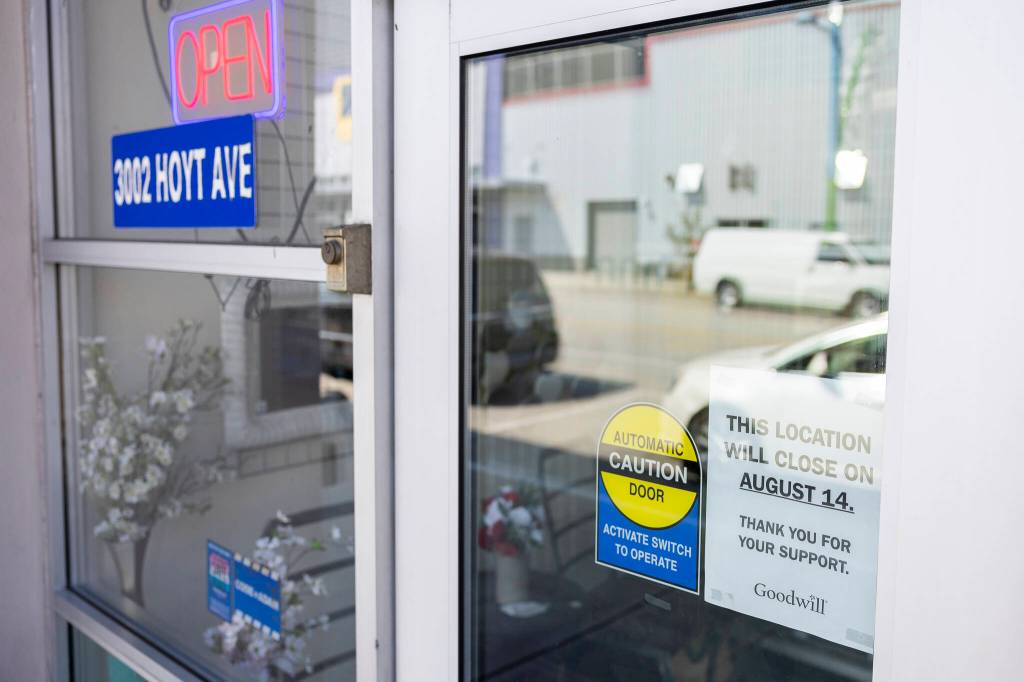 A sign announcing the closing of Goodwill along Hoyt Avenue is visible through the door on Monday, Aug. 3, 2026 in Everett, Washington. (Olivia Vanni / The Herald)