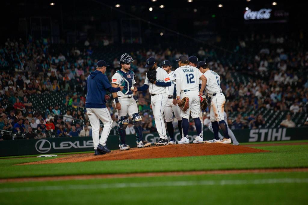 Seattle Mariners manager Dan Wilson (left) visits the mound to remove Seranthony Domínguez (glove at face) during an 8-0 loss to the Detroit Tigers at T-Mobile Park in Seattle, Washington on Tuesday, August 4, 2026. (Photo courtesy of Mason Coe)