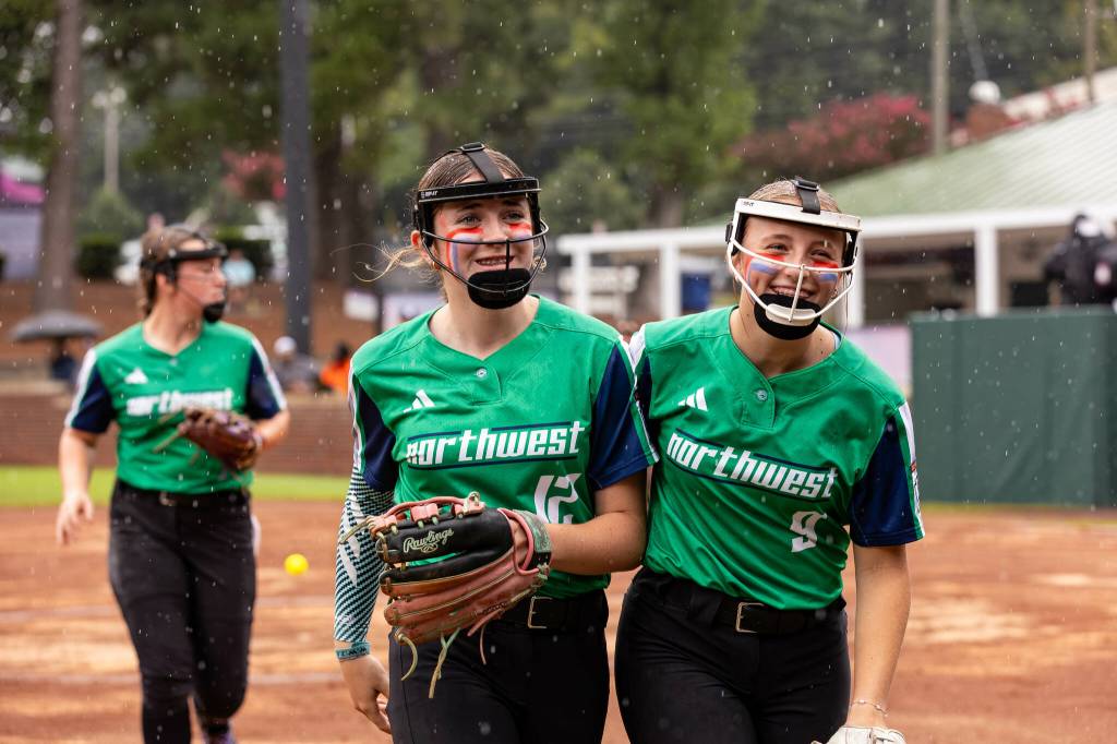 Snohomish Little Leaguers Madison Tawney (12) and Jocelynn Day (9) celebrate a win against Texas on Tuesday at Stallings Stadium in Greenville, North Carolina. (Photo courtesy of Little League Baseball and Softball)