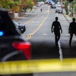 Everett police officers survey the scene of a shooting along East Casino Road on Friday, Oct. 13, 2023 in Everett, Washington. (Olivia Vanni / The Herald)